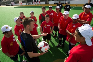 Coach, Matt Gregory, imparts some soccer advice to the students