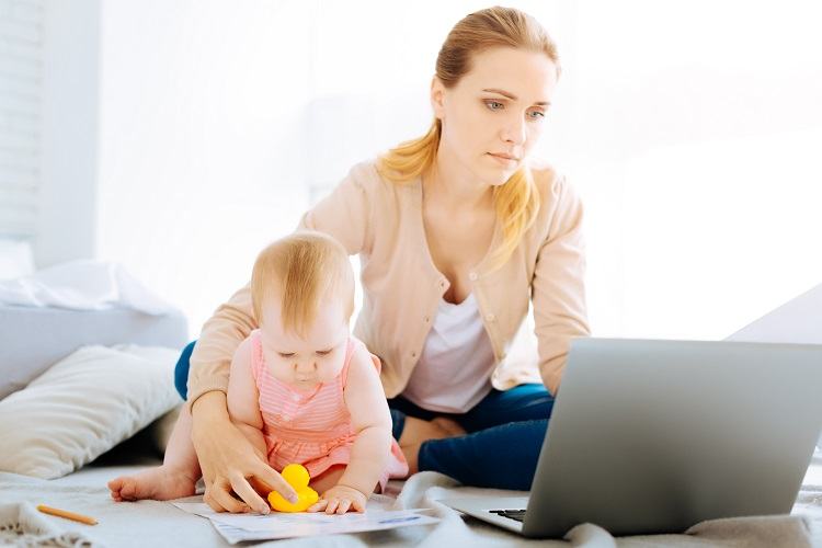 A young mother looks at mortgages with her child