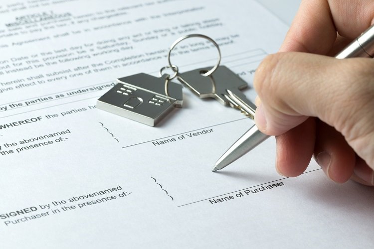 A buyer gets ready to sign the contract of sale