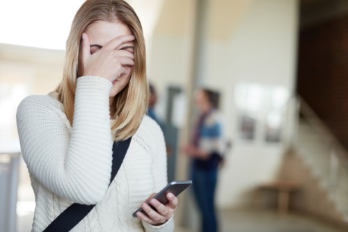 Is it illegal to dismiss someone via text message?